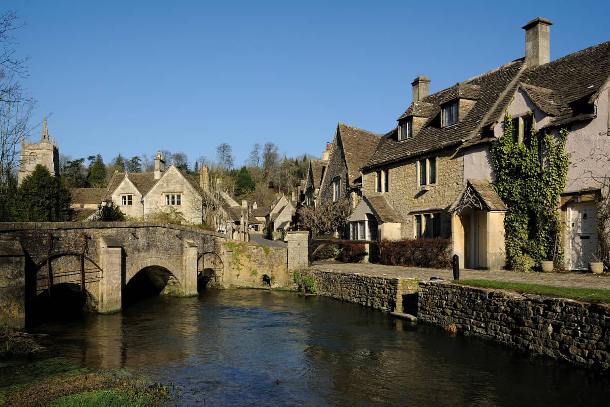 Stone cottages beside the By Brook and the bridge at Castle Combe